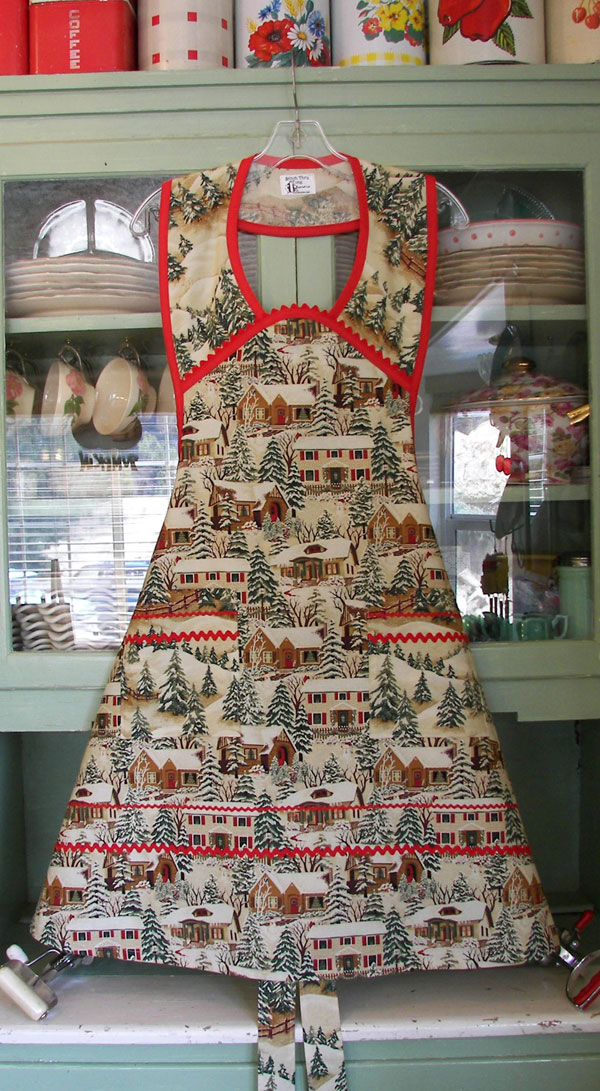 Old Time Village Christmas Apron with red trim and ric rac