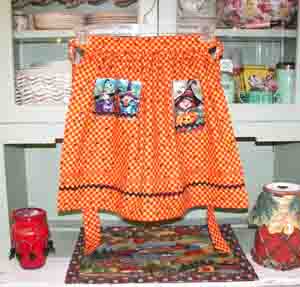 Hokus Pokus  child half apron in orange yellow 